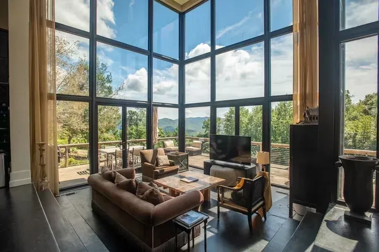 Lounge framed by floor-to-ceiling windows and mountain views