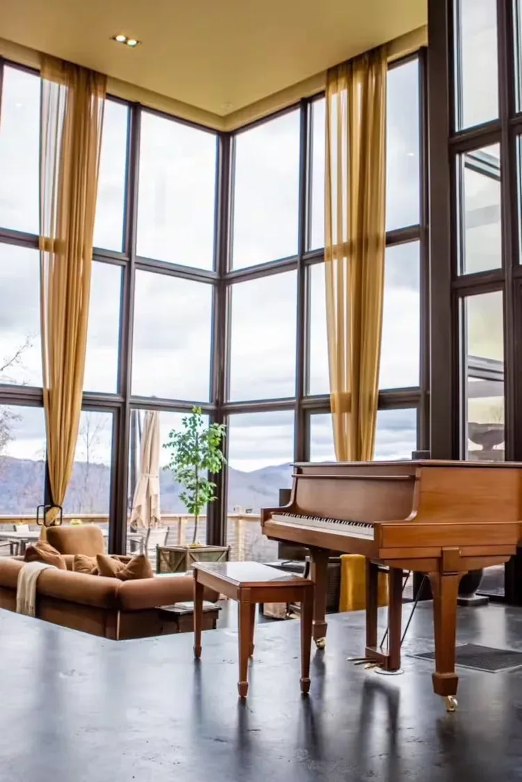 Grand piano beside tall windows at The Redstone Estate
